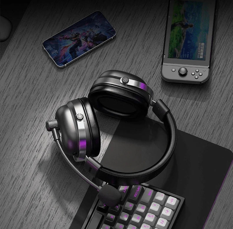 Auscultadores Commander junto a um telemóvel, consola portátil e teclado